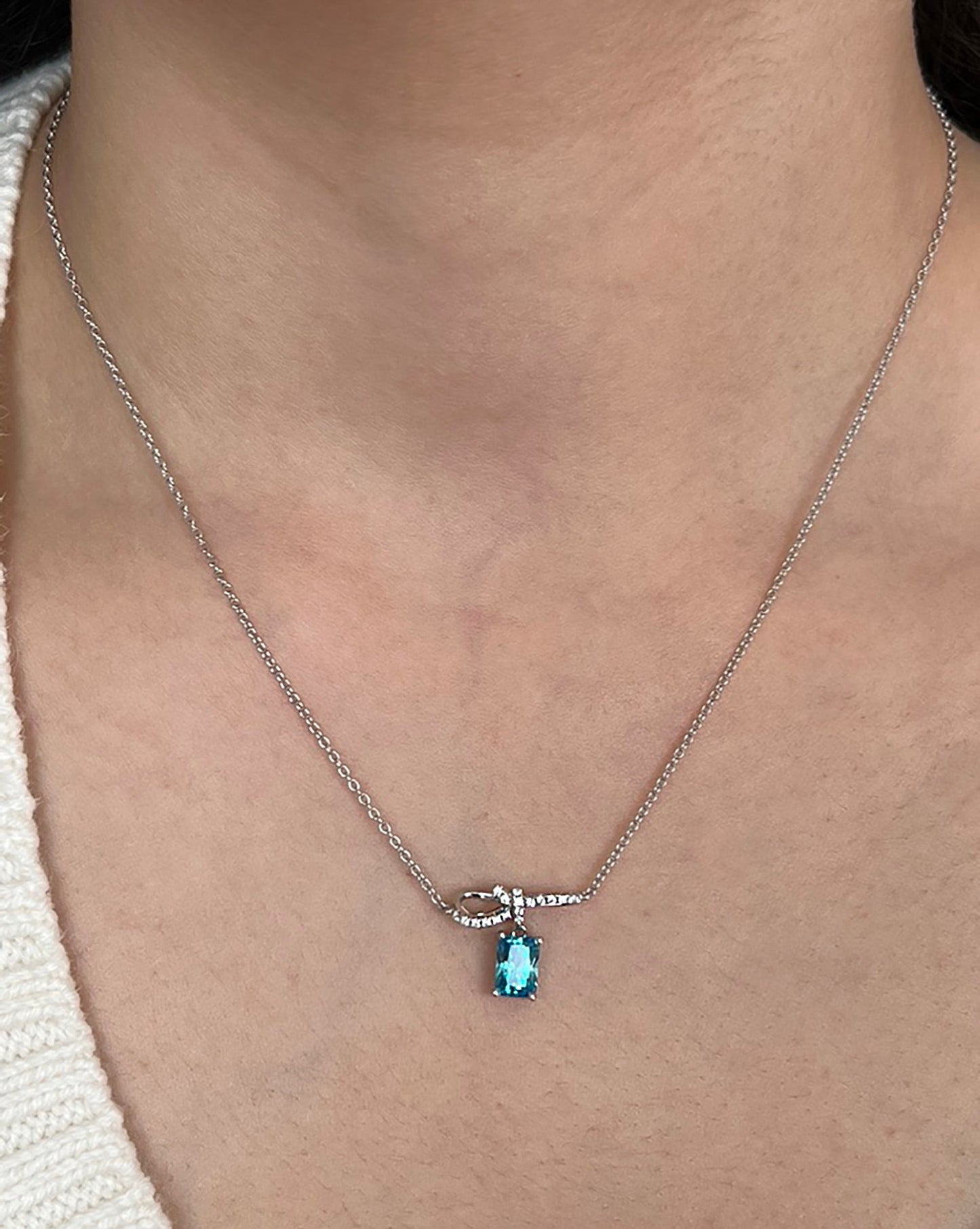 Sterling Silver Bow Pendant Necklace: Blue Cubic Zirconia, Adjustable Chain