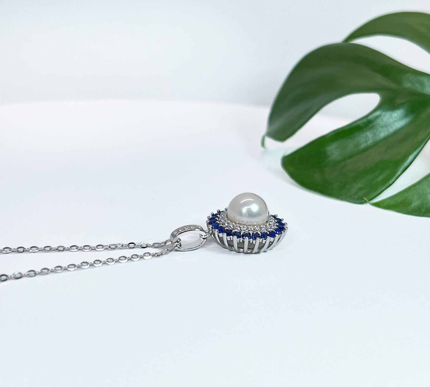Freshwater Pearl & Blue Sapphire Halo Pendant: Rhodium-Plated Silver Necklace