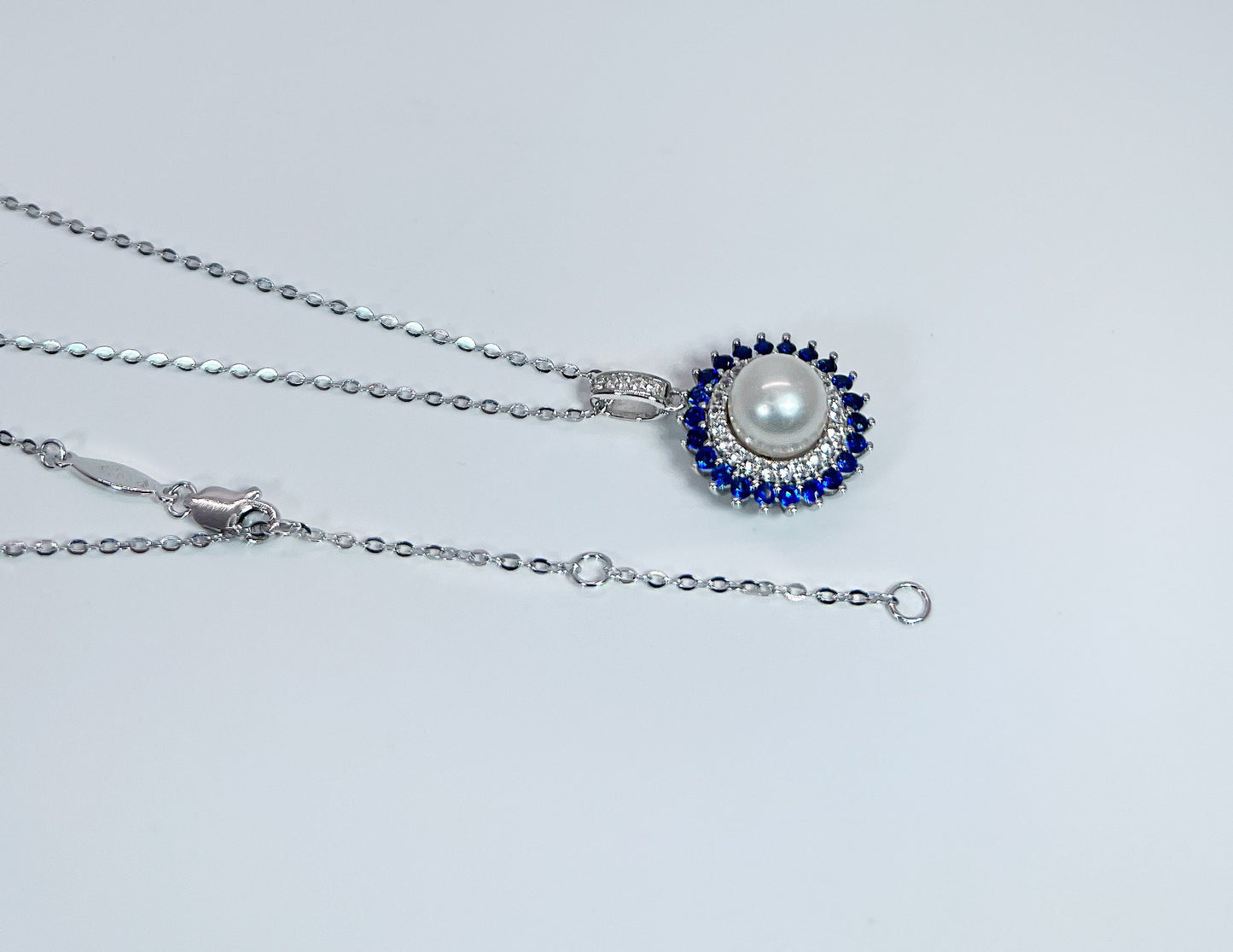 Freshwater Pearl & Blue Sapphire Halo Pendant: Rhodium-Plated Silver Necklace